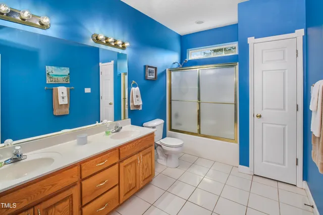 a spacious bathroom with a sink a toilet and shower