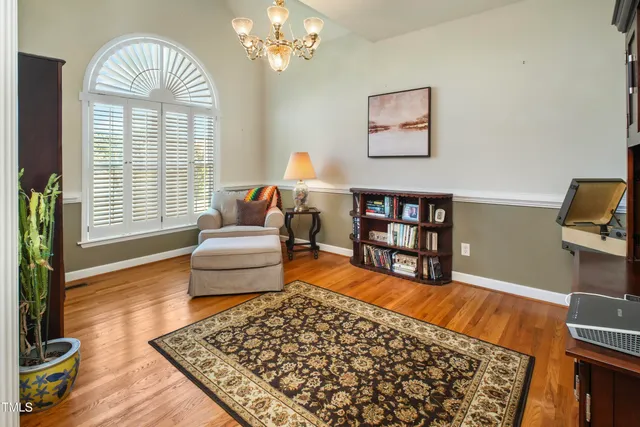 a living room with furniture and a floor to ceiling window