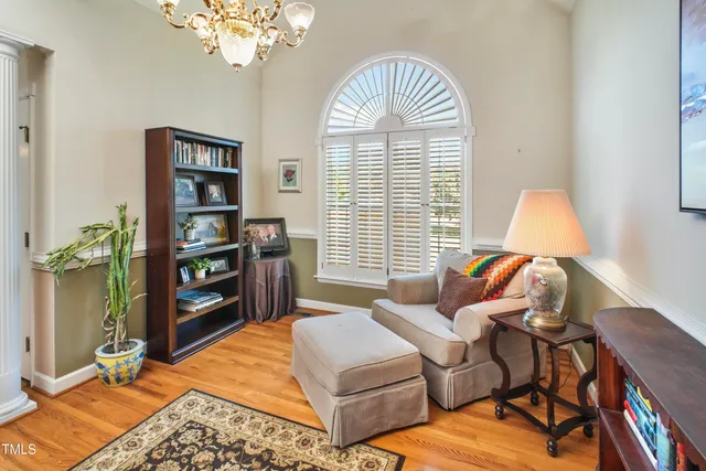 a bedroom with a bed a bookshelf and a chandelier