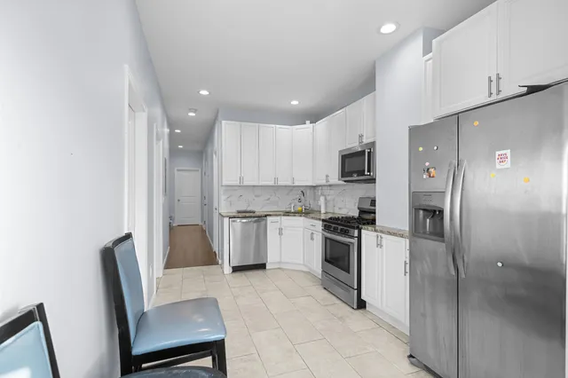 a kitchen with cabinets and stainless steel appliances