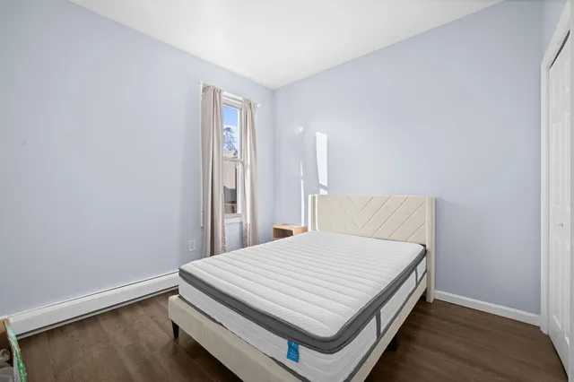 a bed sitting in a bedroom next to a window