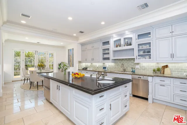 a kitchen with stainless steel appliances granite countertop a stove and a sink