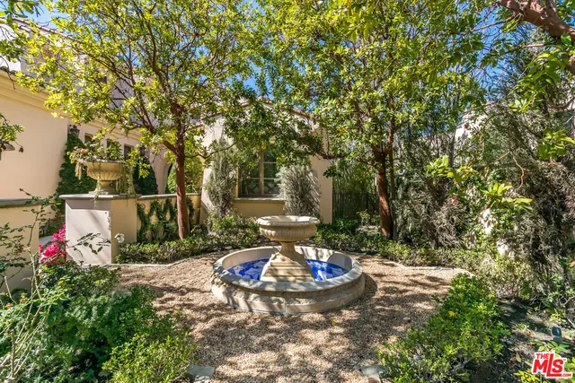 a view of a backyard with table and chairs and potted plants