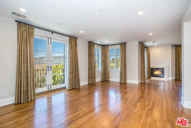 a bedroom with a large bed and a large window