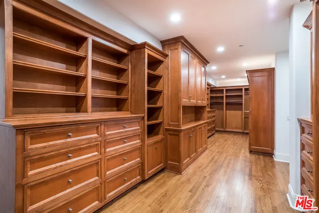 a spacious bathroom with a large mirror vanity and a bathtub