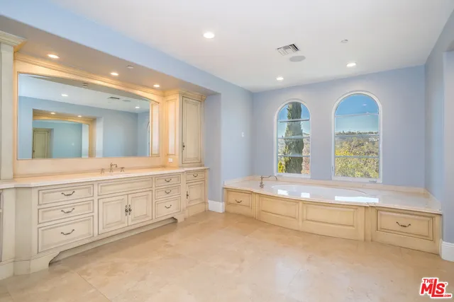 a bathroom with a tub shower and sink