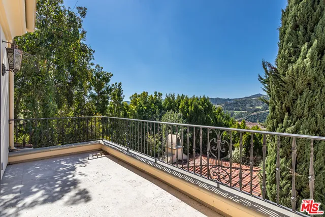 a living room with furniture and a book shelf