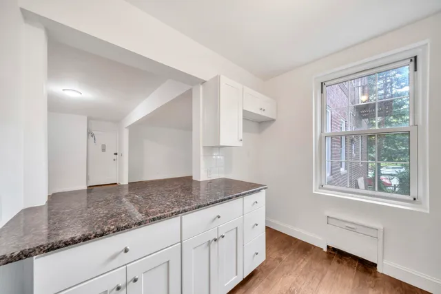 an empty room with wooden floor