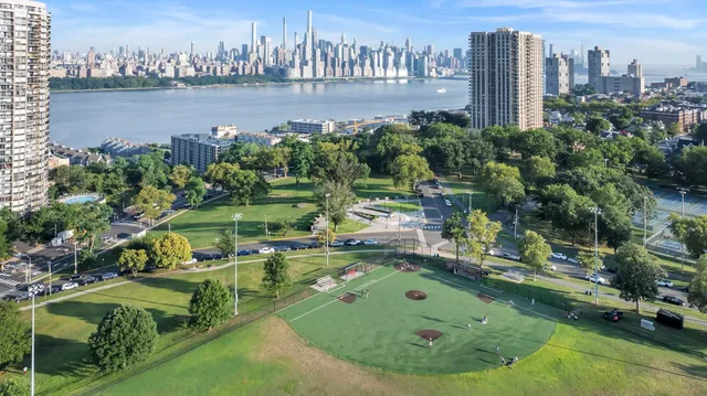 an aerial view of residential house with outdoor space and lake view in back