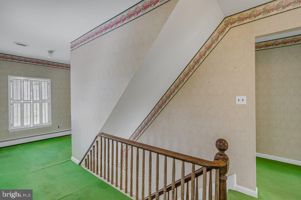 742 Main Street Reedville, VA 22539 - Photo 16 of 66 Charming staircase in a bright hallway.