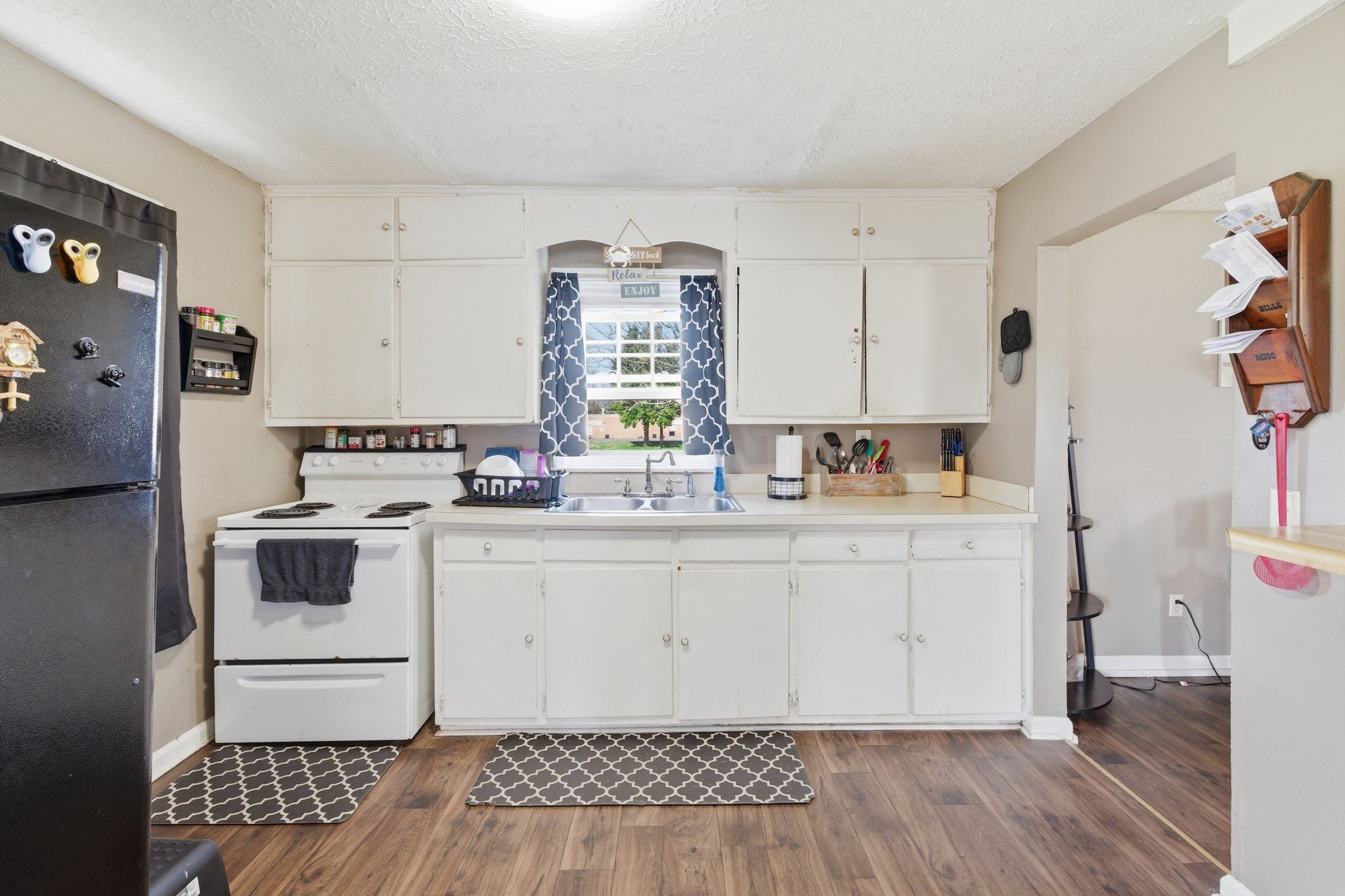 703 McCurdy Road White House, TN 37188 - Photo 15 of 26 a white kitchen with a white stove top oven and sink