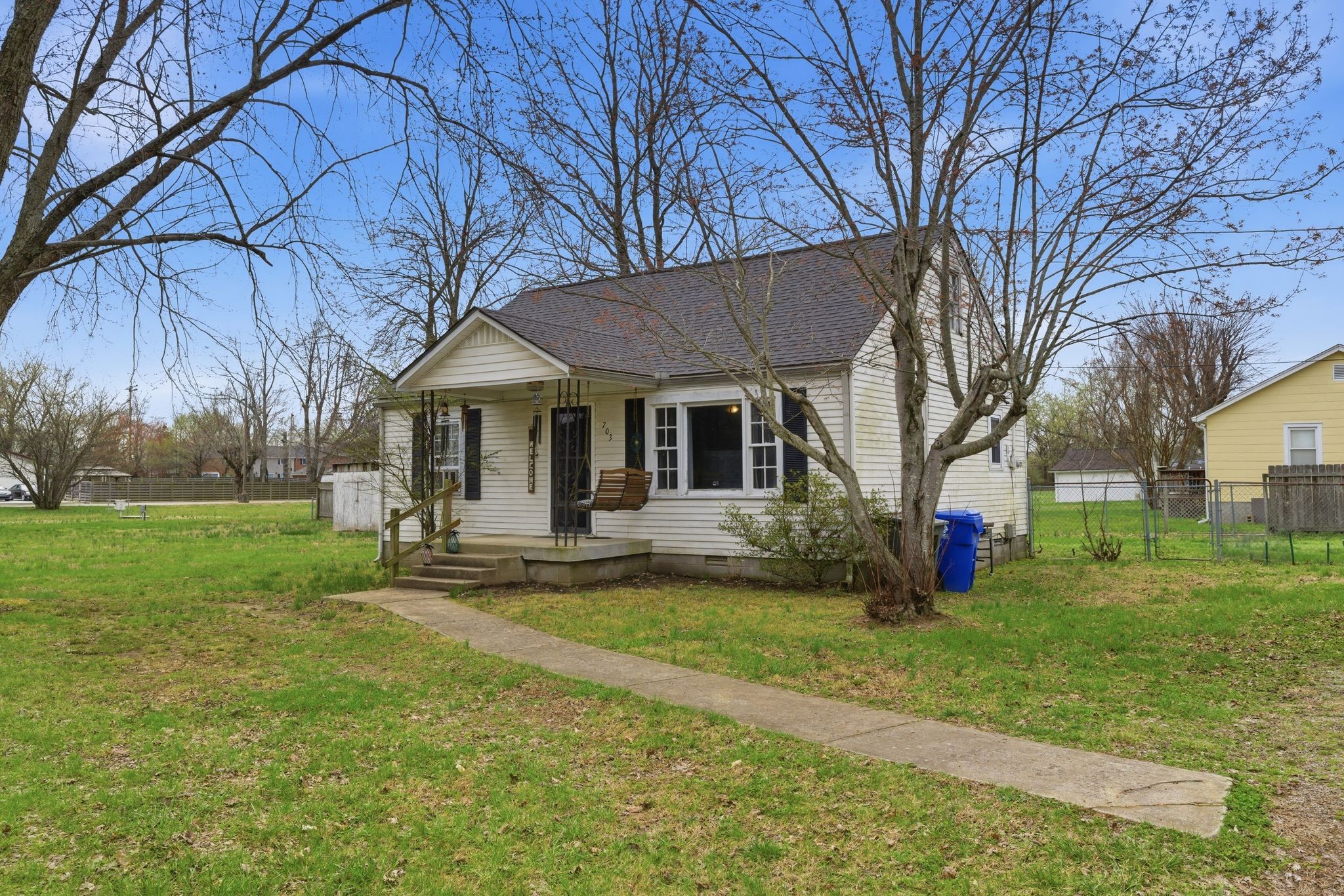 703 McCurdy Road White House, TN 37188 - Photo 2 of 26 a front view of a house with garden and trees