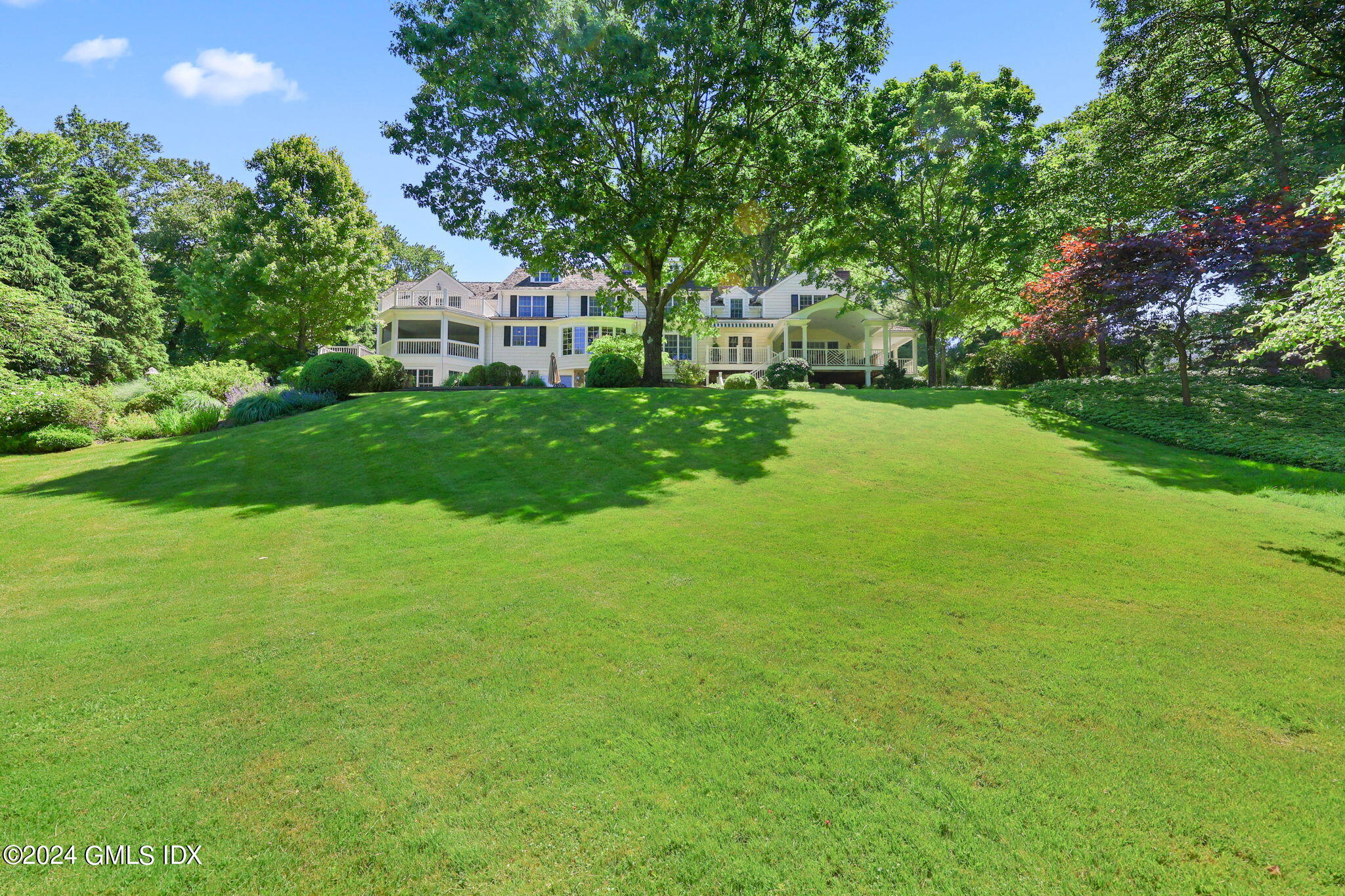 21 Dempsey Lane Greenwich, CT 06830 - Photo 22 of 32 a view of a house next to a big yard