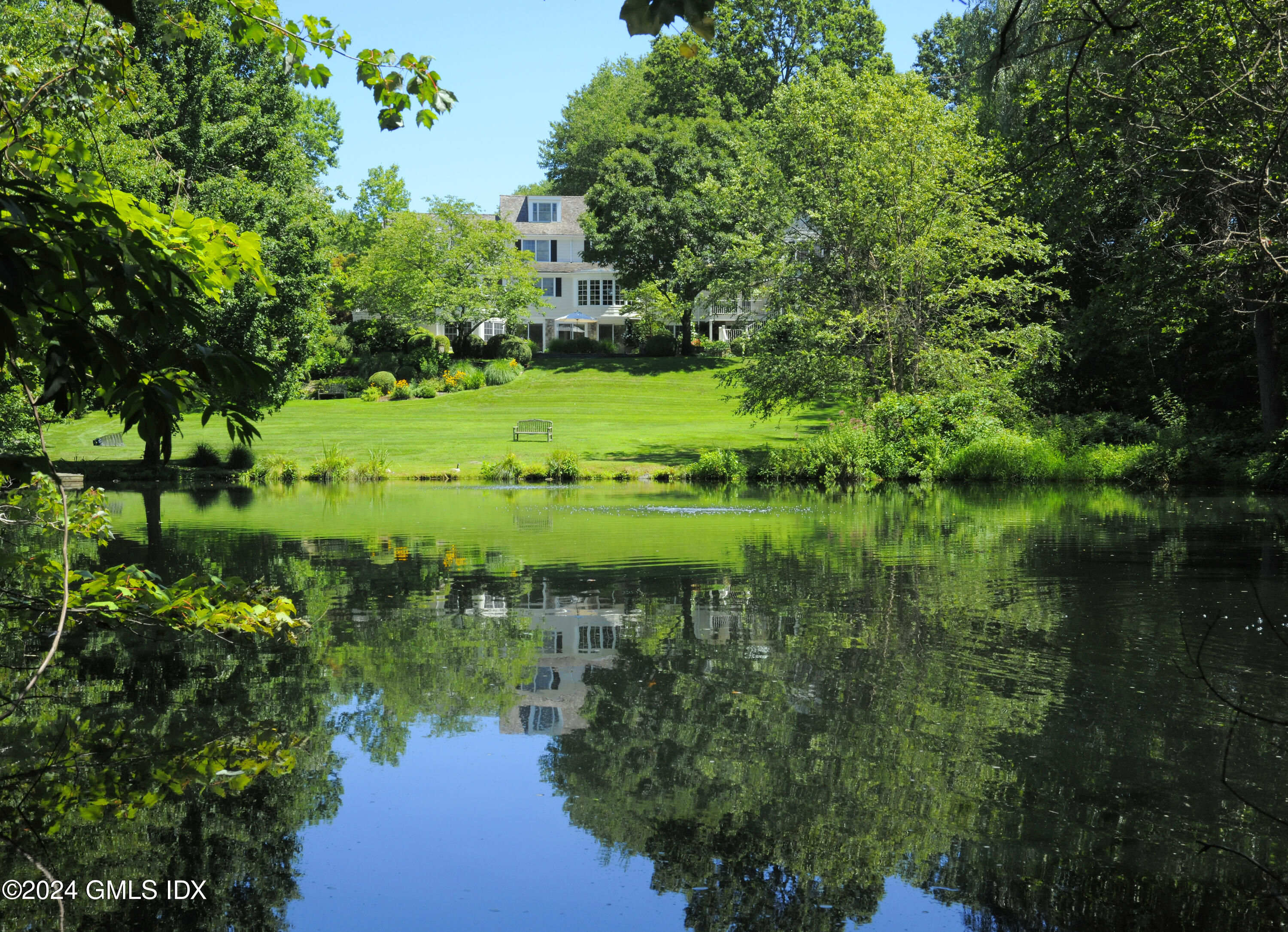 21 Dempsey Lane Greenwich, CT 06830 - Photo 24 of 32 a view of a garden with a lake
