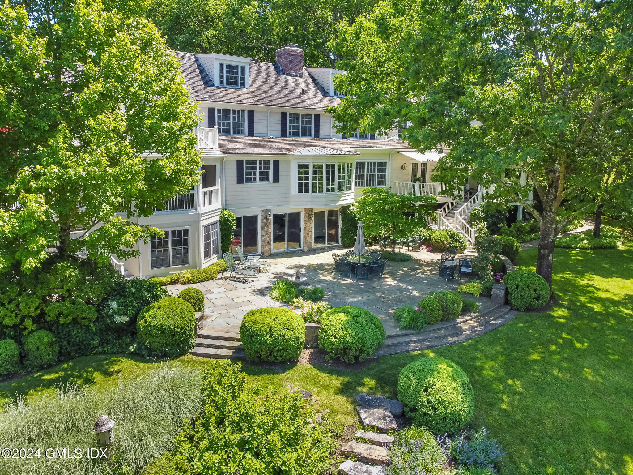 21 Dempsey Lane Greenwich, CT 06830 - Photo 28 of 32 a front view of a house with a yard