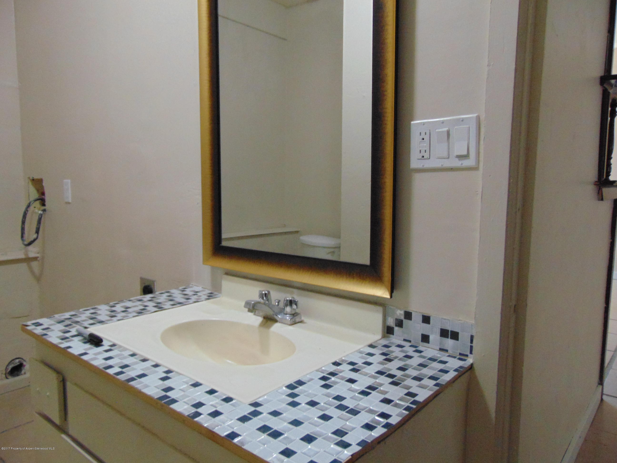 657 Park Avenue Rifle, CO 81650 - Photo 23 of 41 a bathroom with a sink and a mirror