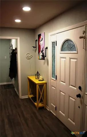 wooden floor with table and chairs