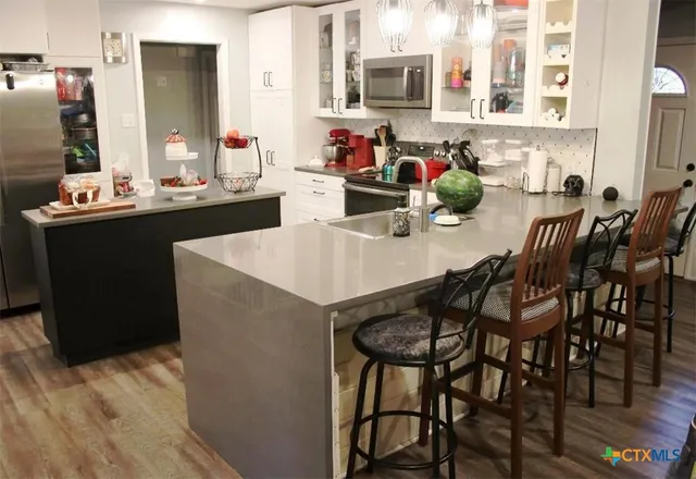 a kitchen with a dining table chairs and a kitchen island