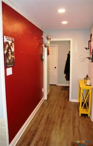 an empty room with wooden floor and furniture
