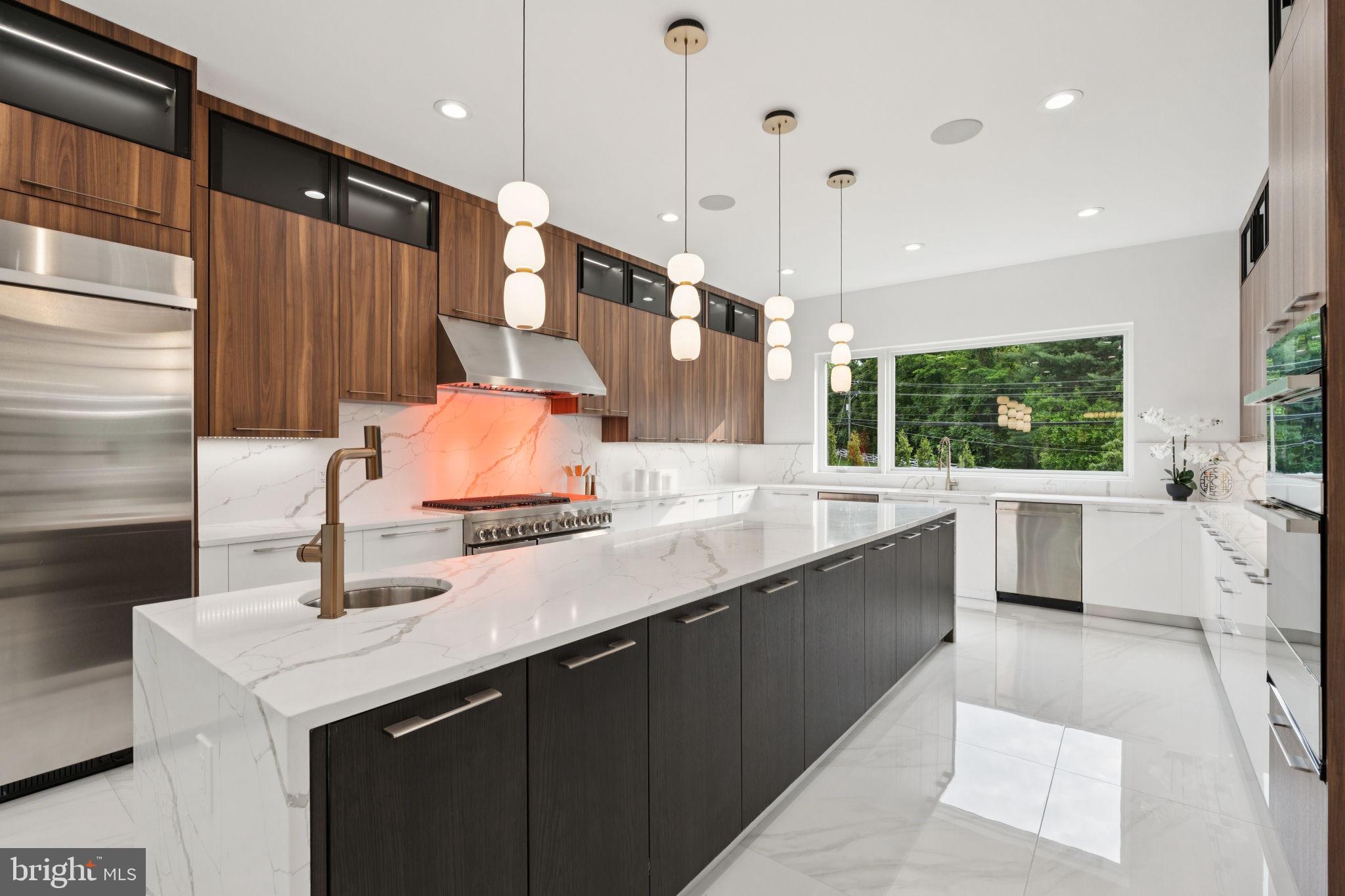 2209 Hunter Mill Road Vienna, VA 22181 - Photo 12 of 63 a kitchen with stainless steel appliances kitchen island a sink stove and cabinets