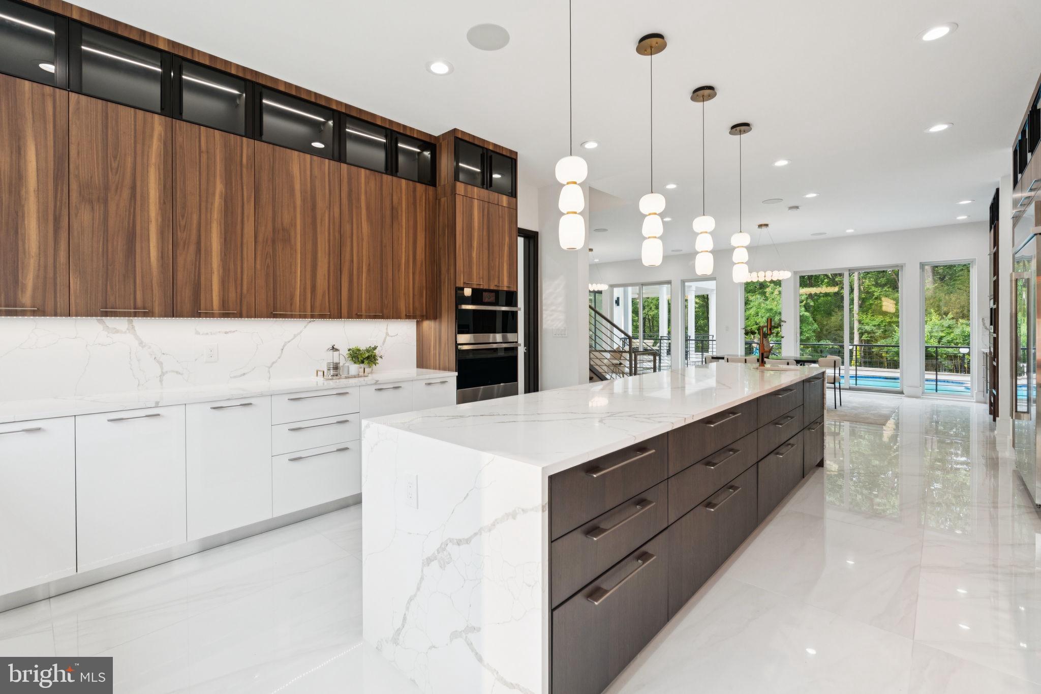 2209 Hunter Mill Road Vienna, VA 22181 - Photo 13 of 63 a kitchen with kitchen island granite countertop a sink a counter top space and cabinets