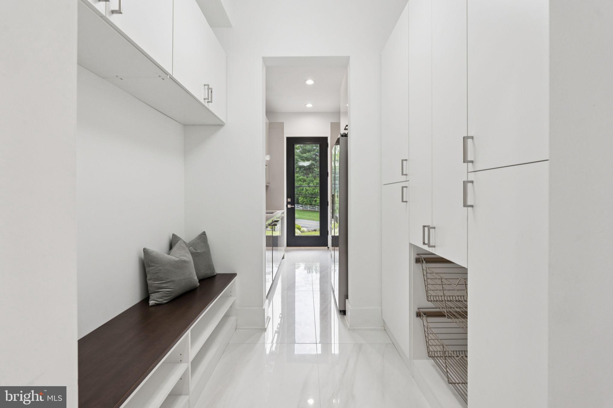 2209 Hunter Mill Road Vienna, VA 22181 - Photo 14 of 63 a hallway with white doors wooden floor and glass door
