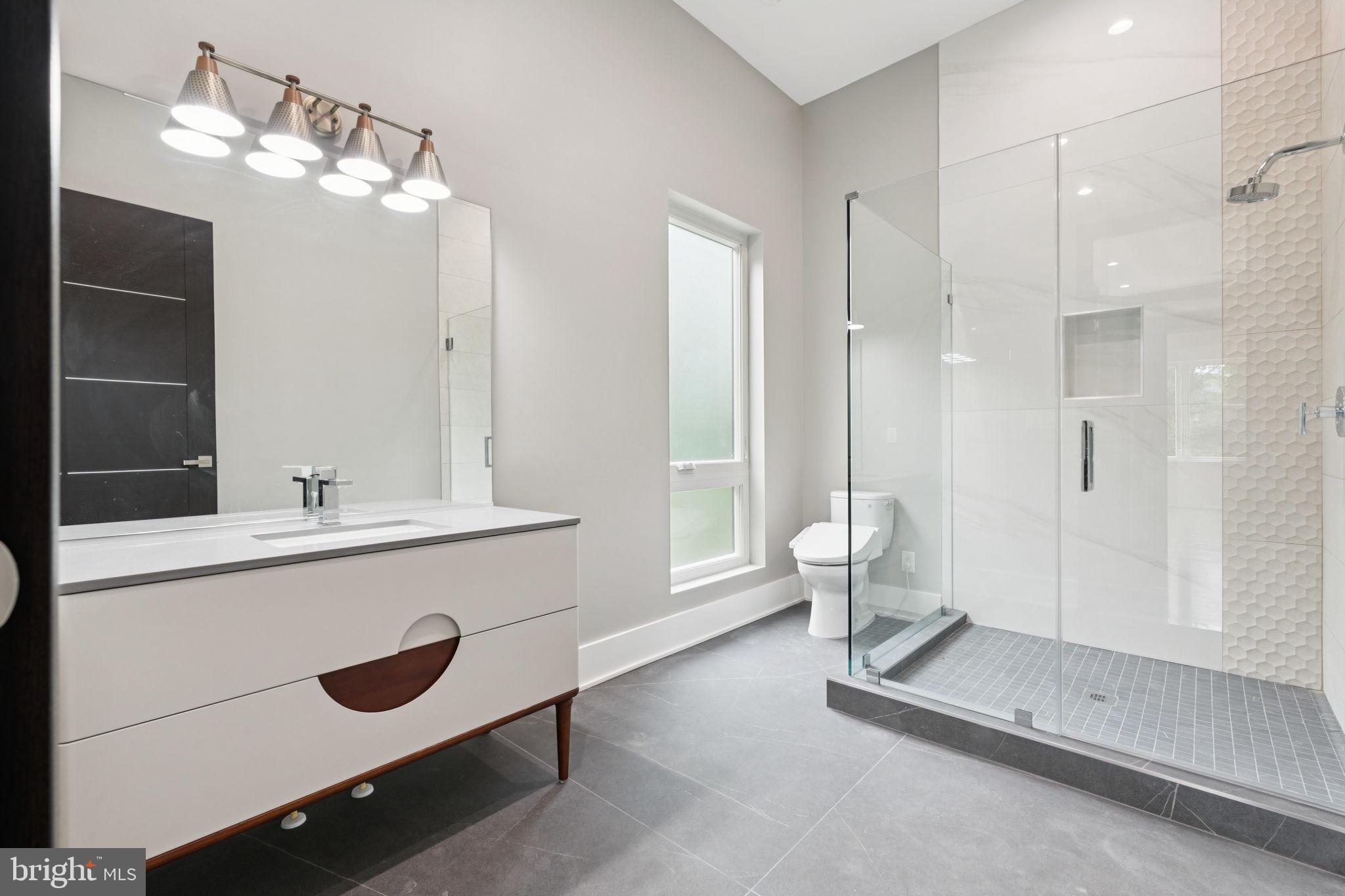 2209 Hunter Mill Road Vienna, VA 22181 - Photo 27 of 63 a bathroom with a double vanity sink mirror and toilet