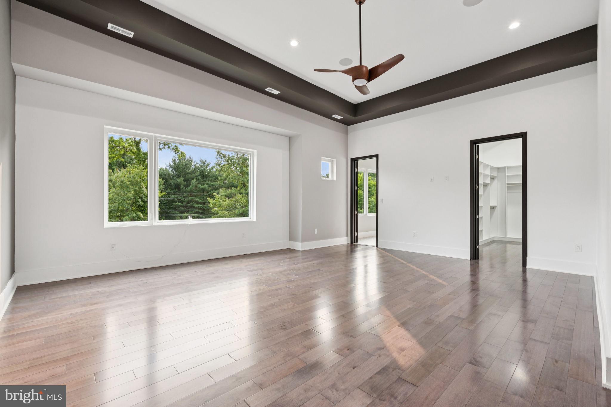 2209 Hunter Mill Road Vienna, VA 22181 - Photo 30 of 63 a view of an empty room with wooden floor and a window