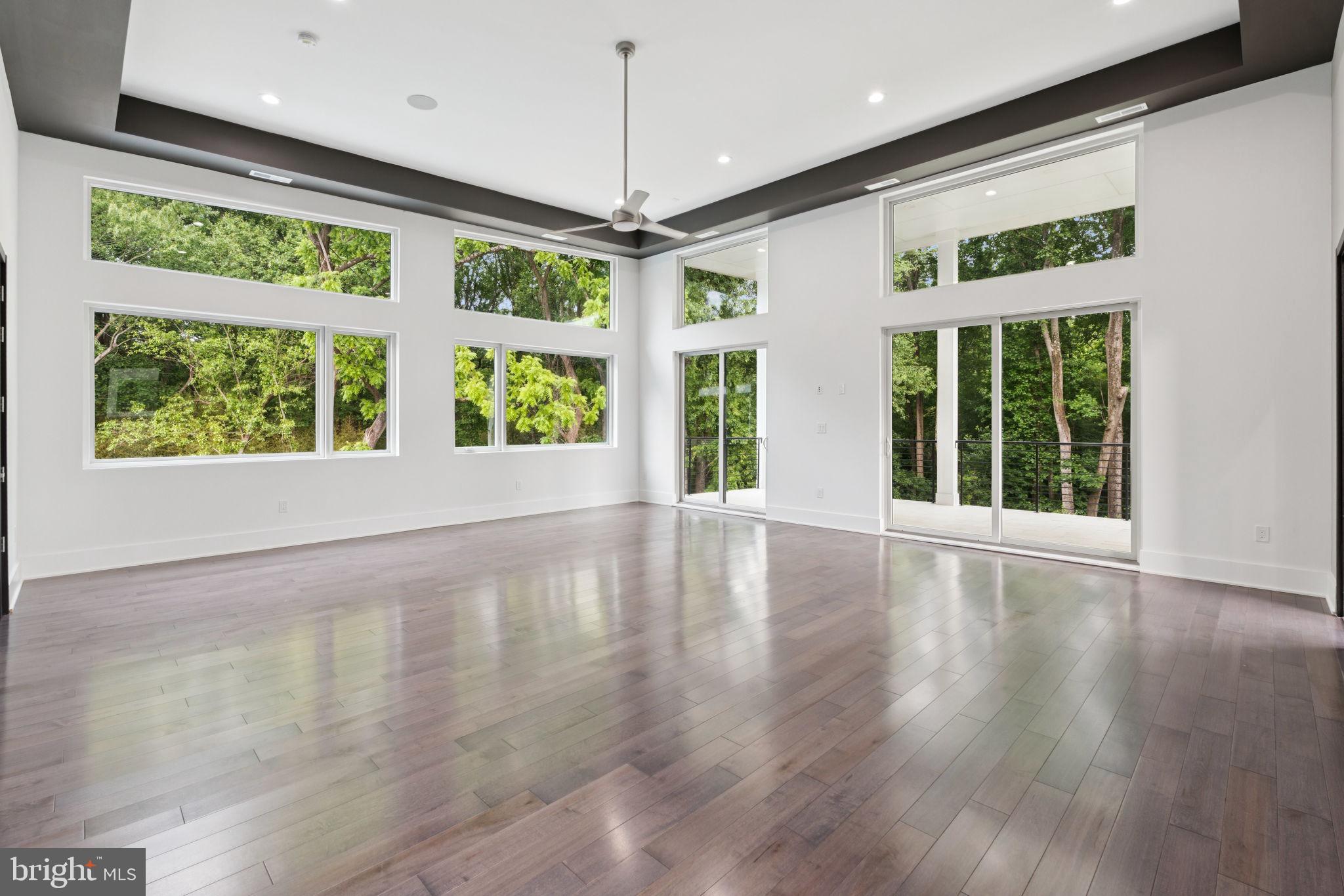 2209 Hunter Mill Road Vienna, VA 22181 - Photo 36 of 63 a view of an empty room with wooden floor and a window