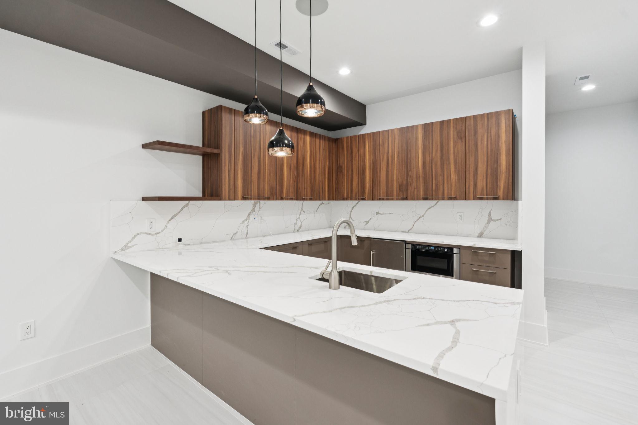 2209 Hunter Mill Road Vienna, VA 22181 - Photo 49 of 63 a kitchen with granite countertop a sink a stove and a wooden cabinets