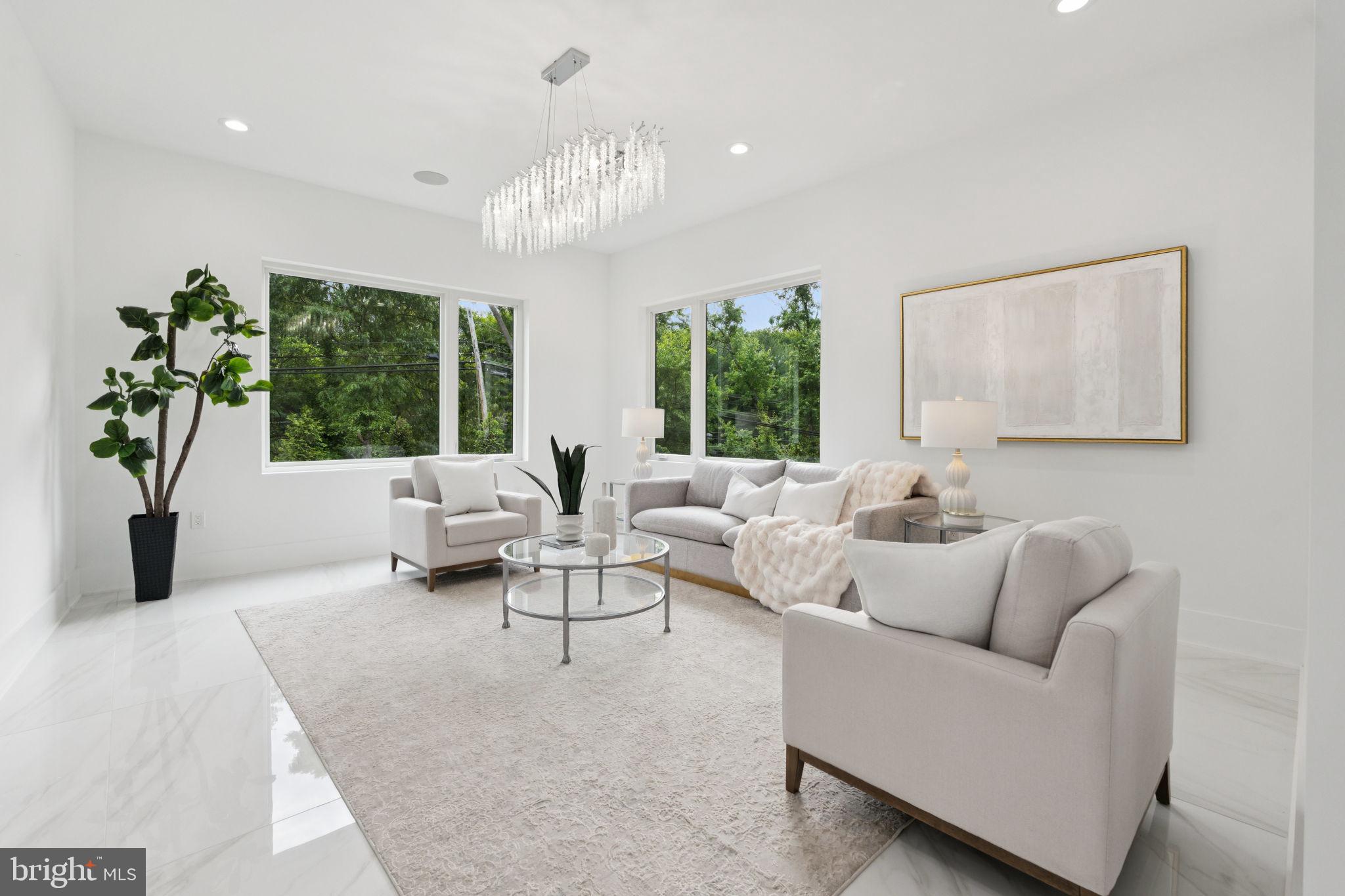 2209 Hunter Mill Road Vienna, VA 22181 - Photo 6 of 63 a living room with furniture and a chandelier