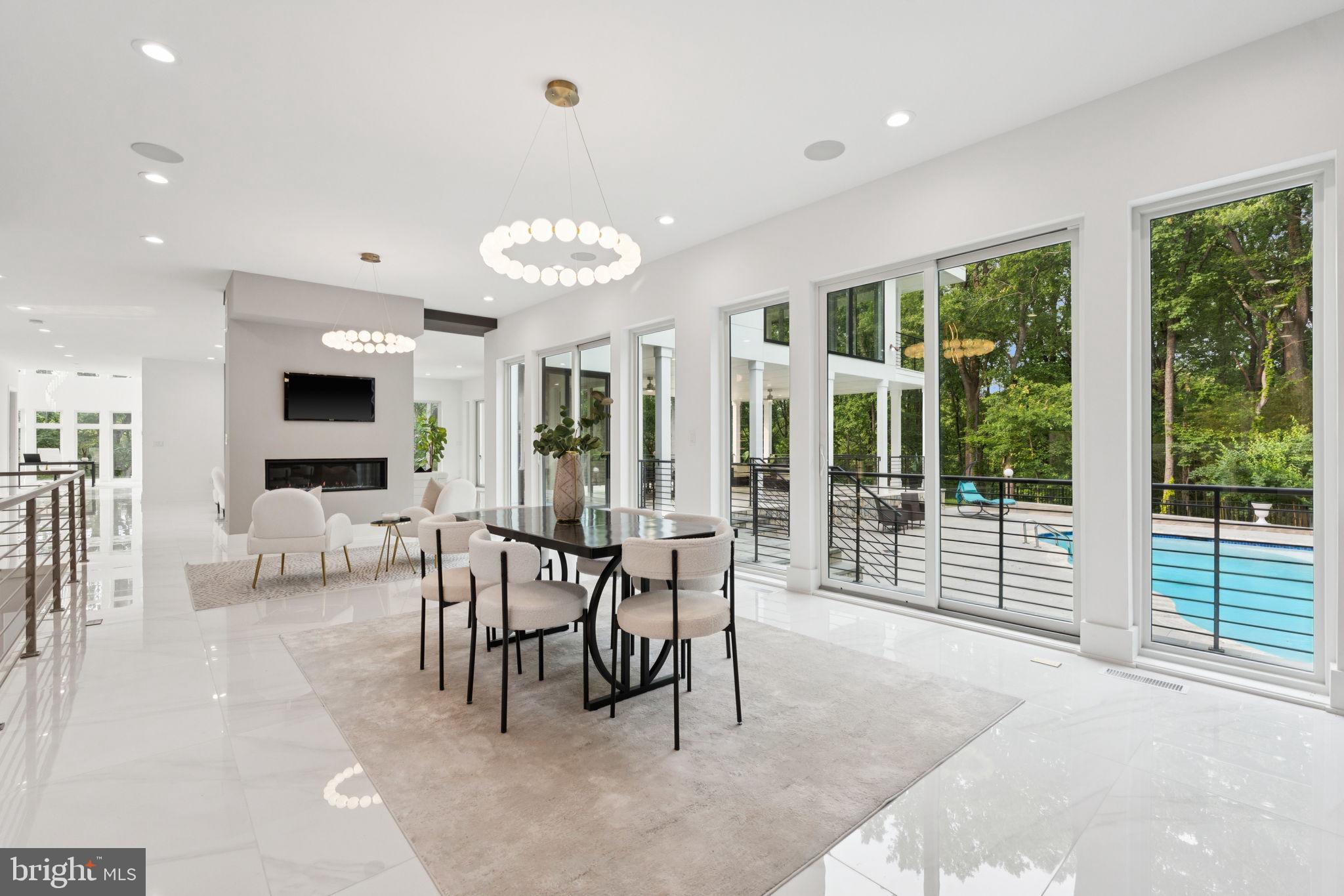 2209 Hunter Mill Road Vienna, VA 22181 - Photo 8 of 63 a view of a dining room with furniture large windows and a chandelier
