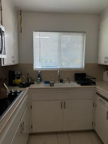 a kitchen with stainless steel appliances white cabinets and a sink