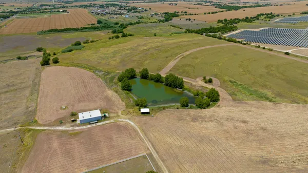 an aerial view of a house with a yard and lake view