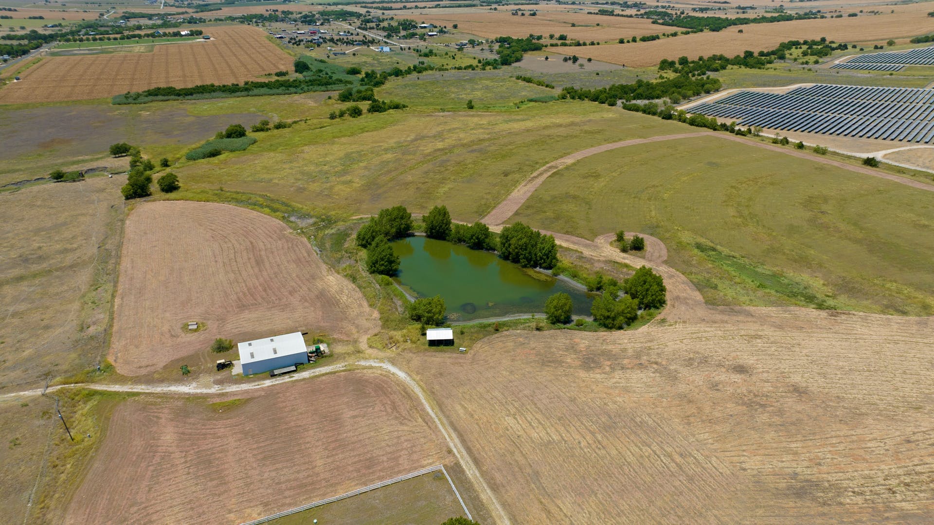 13212 Sandeen Road Coupland, TX 78615 - Photo 2 of 17 an aerial view of a house with a yard and lake view