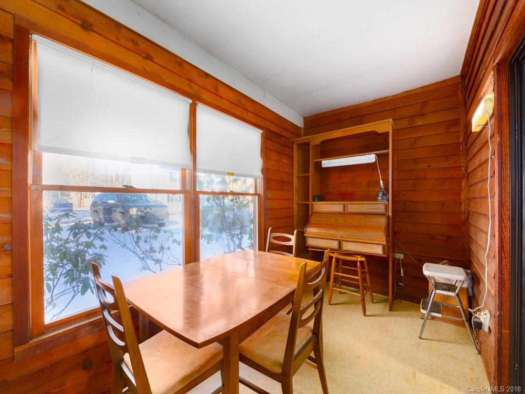 551 Bee Tree Road Swannanoa, NC 28778 - Photo 11 of 29 a dining room with furniture and wooden floor