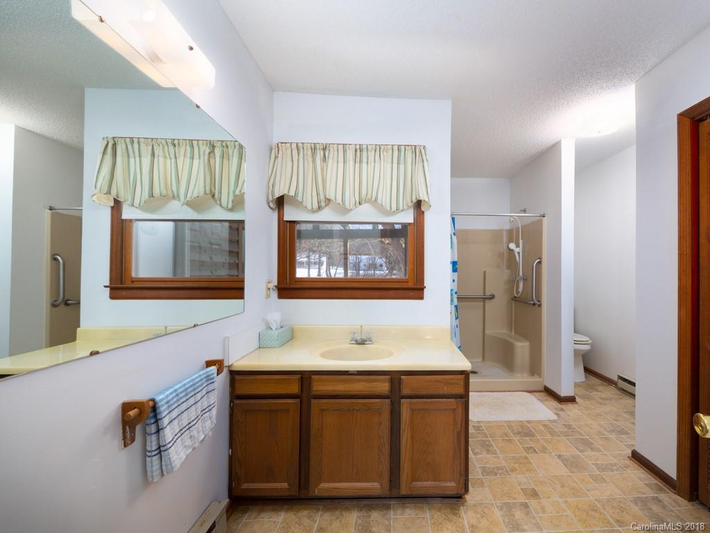 551 Bee Tree Road Swannanoa, NC 28778 - Photo 12 of 29 a bathroom with a sink double vanity and a mirror