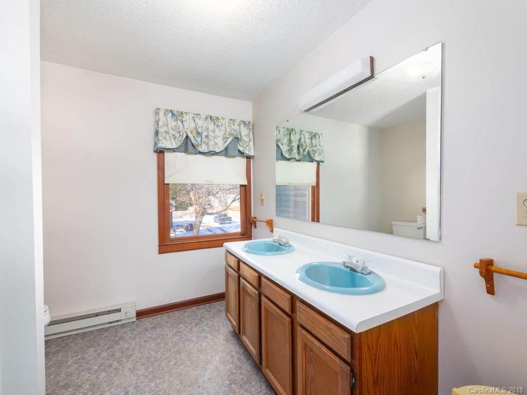 551 Bee Tree Road Swannanoa, NC 28778 - Photo 23 of 29 a bathroom with a sink and a mirror