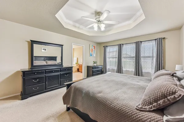 a bedroom with a bed and a dresser