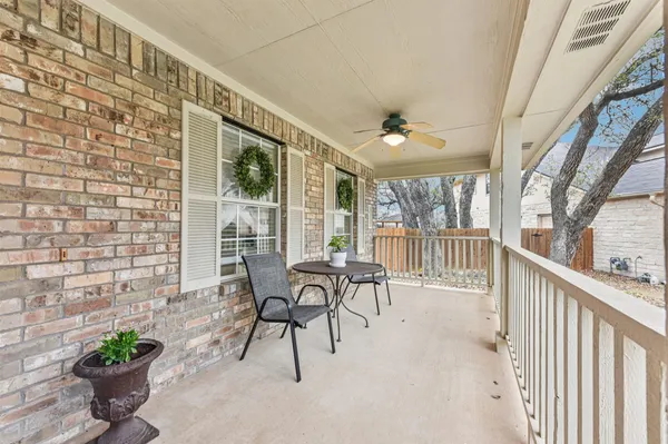 a view of a porch with chairs and backyard