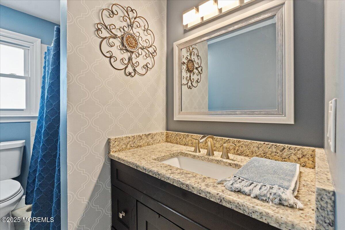 165 Port Road Brick, NJ 08723 - Photo 19 of 48 a bathroom with a granite countertop sink and a toilet