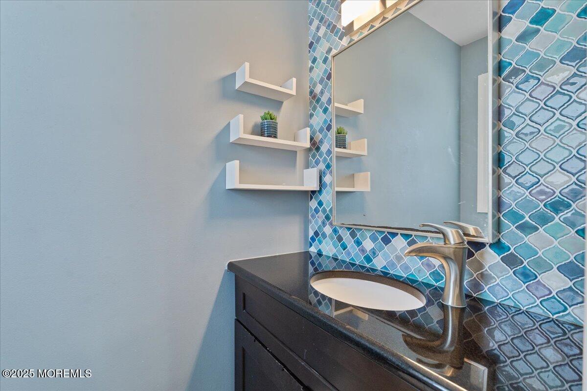 165 Port Road Brick, NJ 08723 - Photo 24 of 48 a bathroom with a granite countertop sink and a mirror