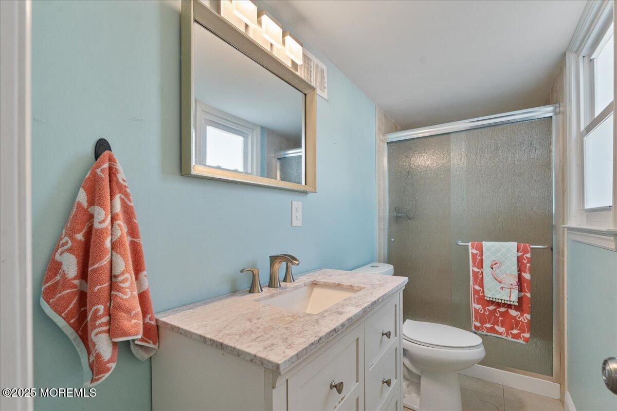 165 Port Road Brick, NJ 08723 - Photo 31 of 48 a bathroom with a sink toilet and vanity