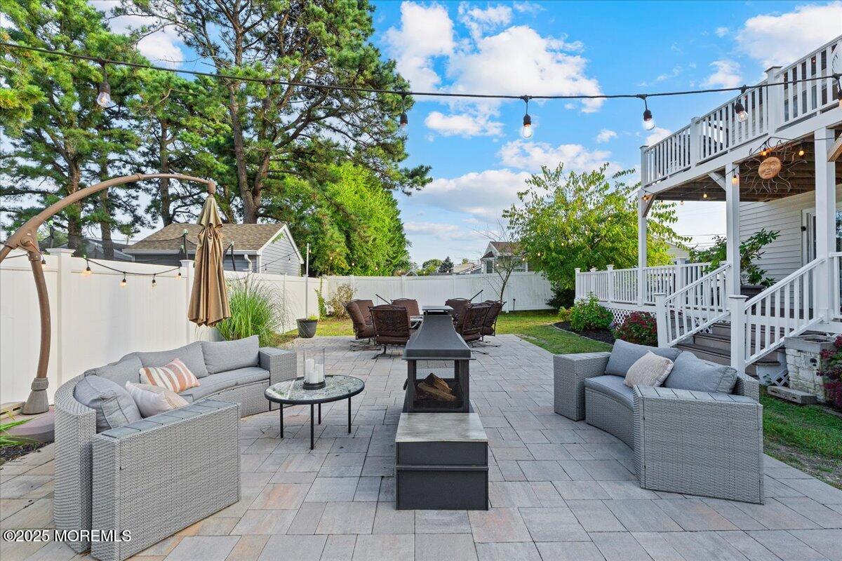 165 Port Road Brick, NJ 08723 - Photo 37 of 48 a view of a patio with couches and a fire pit and a fire pit
