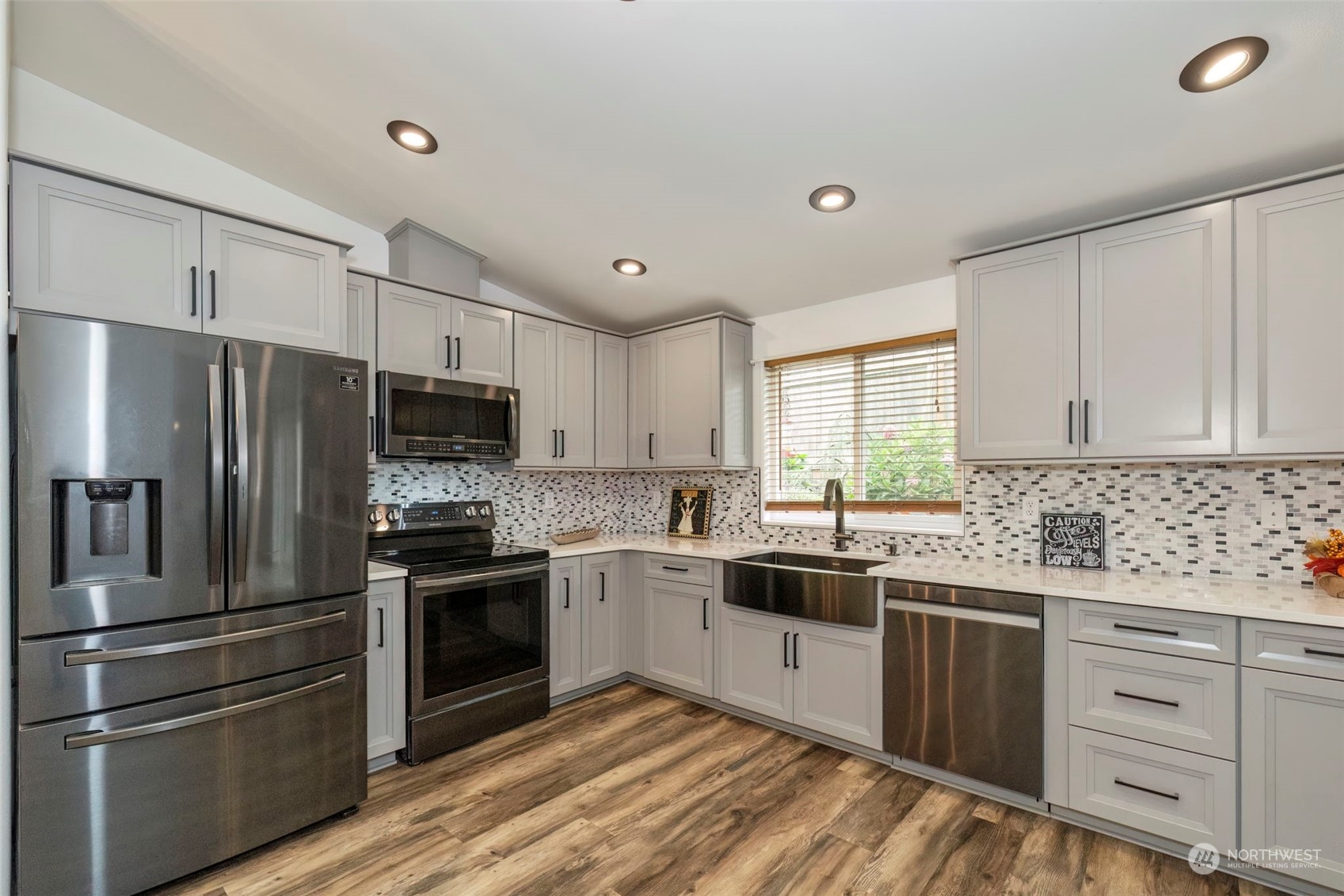 27474 Gamble Bay Road Northeast Kingston, WA 98346 - Photo 11 of 40 a kitchen with stainless steel appliances a sink cabinets and a window
