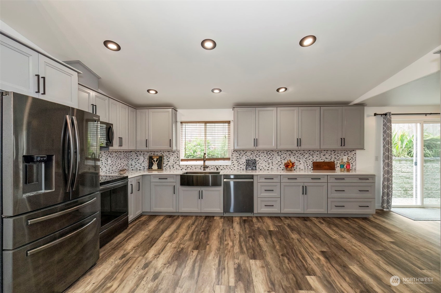 27474 Gamble Bay Road Northeast Kingston, WA 98346 - Photo 12 of 40 a kitchen with lots of counter top space and stainless steel appliances