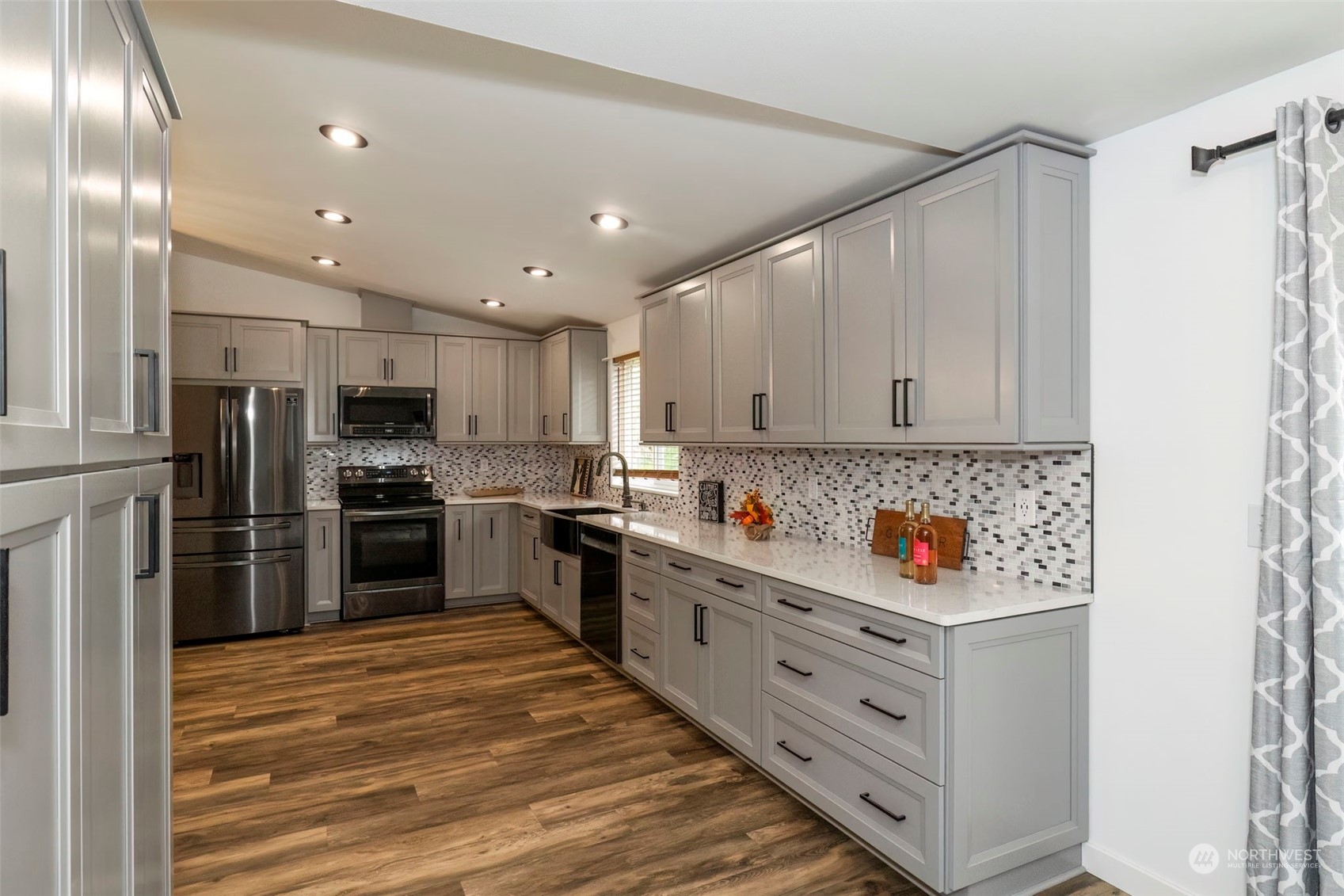 27474 Gamble Bay Road Northeast Kingston, WA 98346 - Photo 14 of 40 a kitchen with stainless steel appliances a refrigerator sink and cabinets