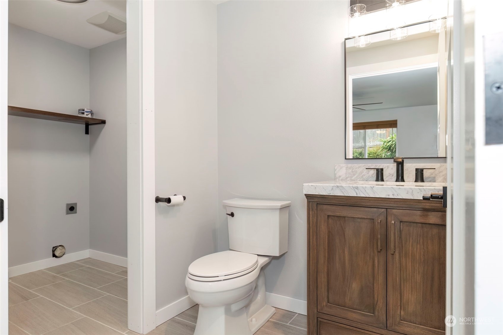 27474 Gamble Bay Road Northeast Kingston, WA 98346 - Photo 19 of 40 a bathroom with a toilet a sink and mirror