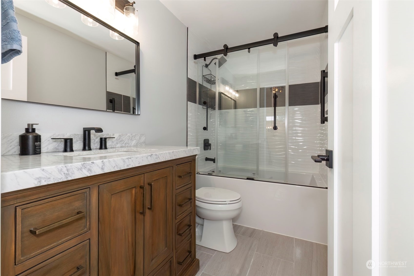 27474 Gamble Bay Road Northeast Kingston, WA 98346 - Photo 20 of 40 a bathroom with a shower toilet sink and mirror