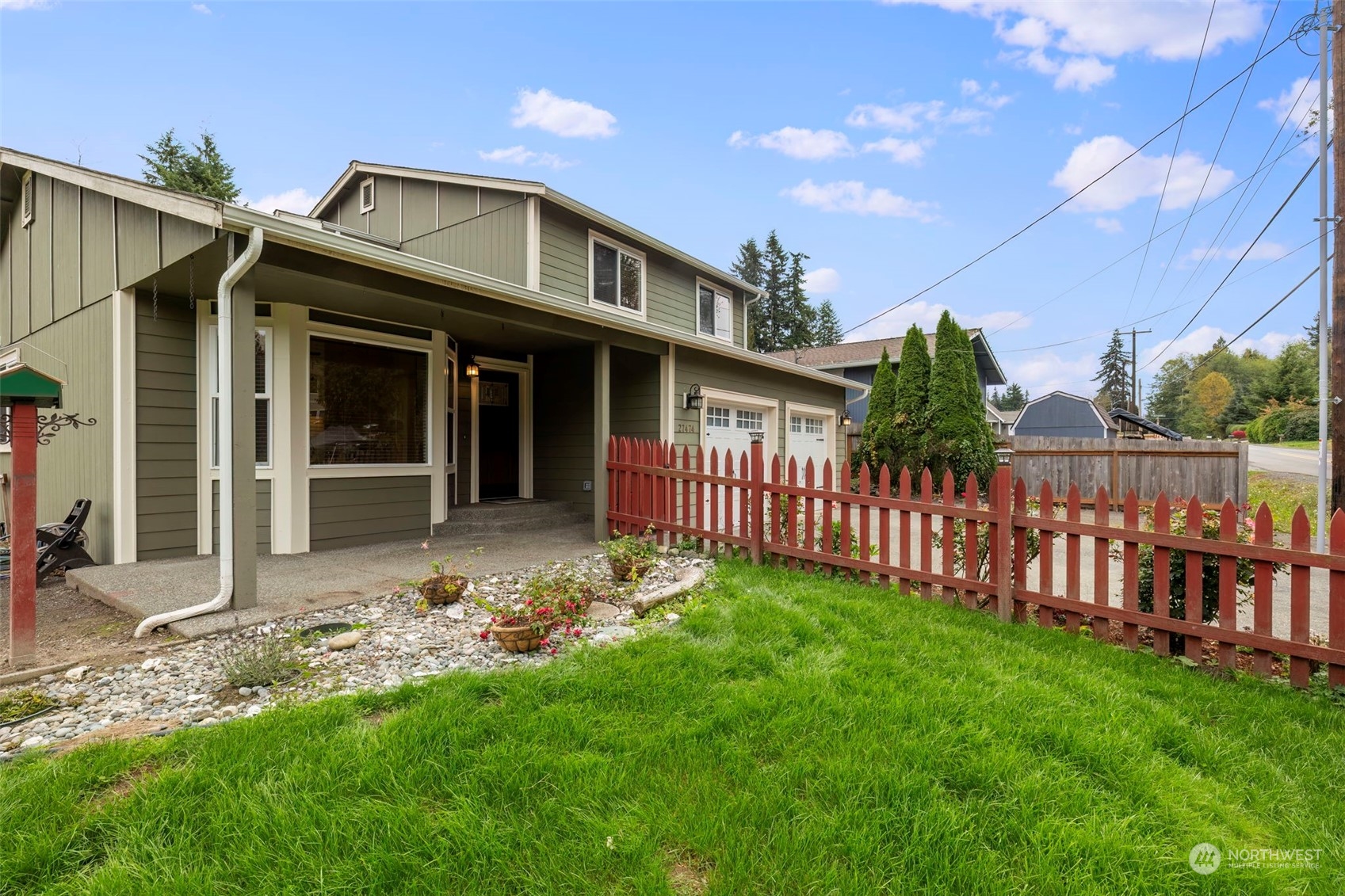 27474 Gamble Bay Road Northeast Kingston, WA 98346 - Photo 2 of 40 a front view of a house with garden